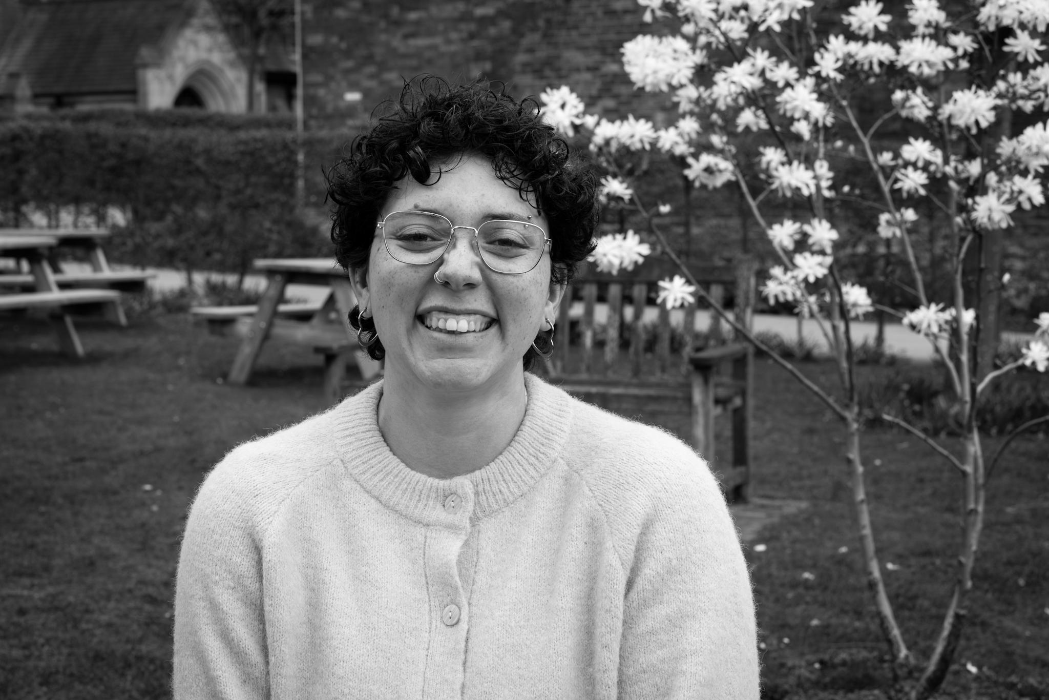 Portrait of Mia, smiling brightly with her teeth.